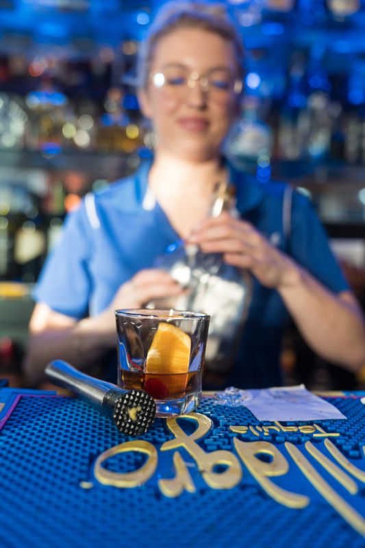 A bartender crafting a signature cocktail at the Bayside Grille sunset bar