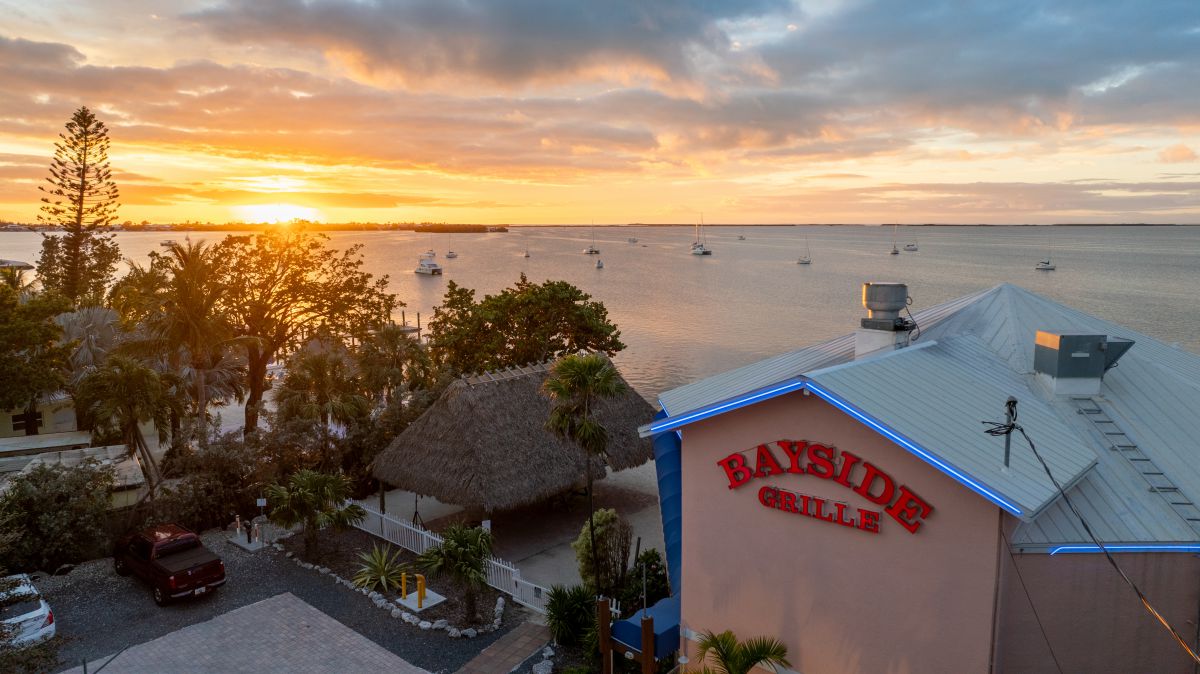 Diners enjoying dinner as the sun sets over Florida Bay